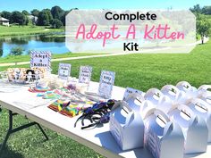 a table that has some bags on it with the words, complete adopt a kitten kit