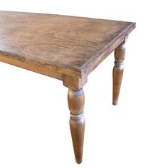 an old wooden table with turned legs on a white background