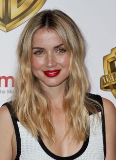 a woman with long blonde hair and red lipstick