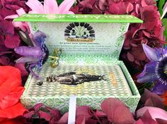 a green box with purple and red flowers in it