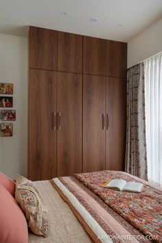 a bedroom with wooden cabinets and a large bed