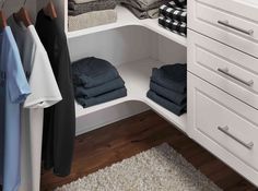 an organized closet with white cabinets and drawers