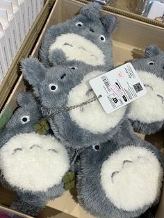 a bunch of stuffed animals are in a box with tags attached to the back of them