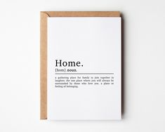 a white card with the words home on it and an envelope underneath that says,