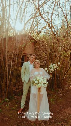 a bride and groom posing for a photo in the woods