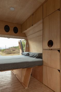 the inside of a camper with a bed in it