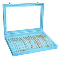 a blue box filled with lots of gold necklaces