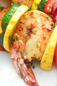 grilled shrimp and vegetable skewers on a white plate