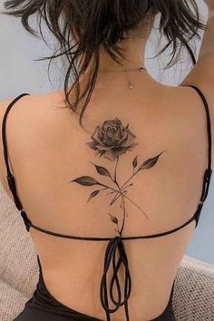 a woman with a rose tattoo on her back