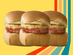 three sandwiches with meat and cheese on buns in front of a multicolored background