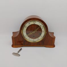 an old clock is sitting next to a key