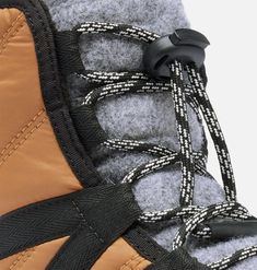 the back side of a pair of snow boots with laces on them and a zippered closure