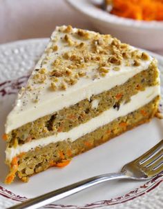 a piece of carrot cake on a plate with a fork