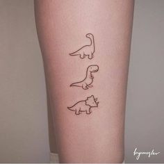 three small dinosaurs on the side of a woman's leg