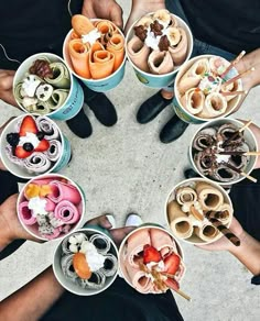 several people are holding bowls with food in them