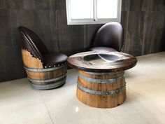 two chairs and a table made out of wine barrels