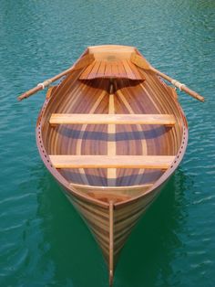 a wooden boat floating on top of a body of water