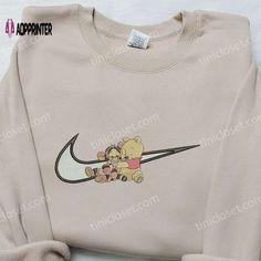 Introducing the Winnie The Pooh and Tiger x Nike Swoosh Embroidered Sweatshirt, a unique collaboration that combines the charm of Nike Cartoon, Nike Inspired, Embroidered Apparel, Kaedehara Kazuha, Best Family Gifts, Gaming Hoodie, Embroidered Shirts, Shirt Nike, Custom Nikes