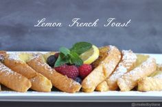 lemon french toast with berries and powdered sugar on a white plate, ready to be eaten