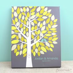 a wedding guest book with a tree on the front and birds on the back cover