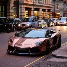 a very nice looking car parked on the side of the road in front of some cars