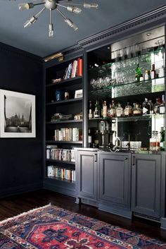 a room that has a rug and some shelves with liquor bottles on top of it