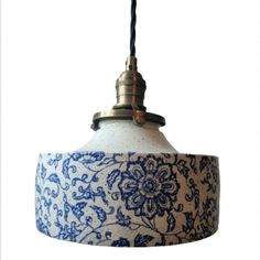 a blue and white lamp hanging from a ceiling