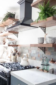 the kitchen is clean and ready for us to use it's natural wood shelves