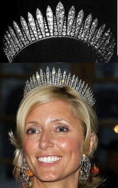 a woman wearing a tiara and smiling at the camera