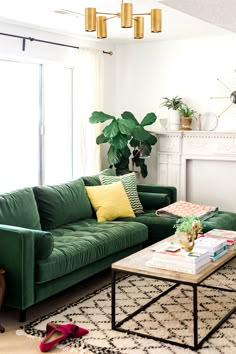 a green couch sitting next to a table in a living room