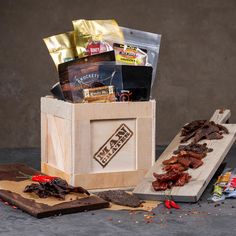 a wooden box filled with assorted snacks