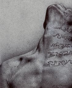 the back of a man's chest with writing on it