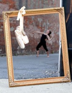 a mirror with a reflection of a person doing a dance move in front of it