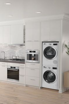 a kitchen with white cabinets and appliances in the corner, including a washer and dryer