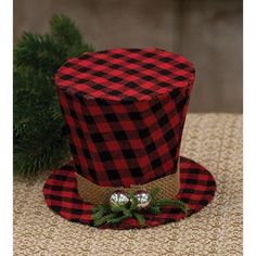 a red and black plaid hat sitting on top of a table