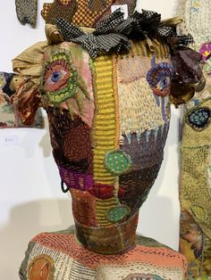 the head of a woman made out of cloths and other fabric material is shown