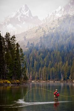 a man in a boat fishing on a lake