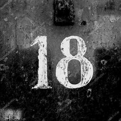 black and white photograph of the number eighteen on an old wall stock photo - 8179