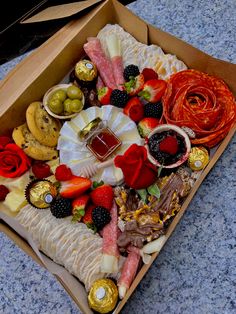 a box filled with assorted fruit and sweets