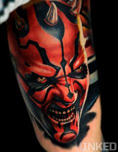 a close up of a person with a tattoo on his leg and face painted to look like darth vader