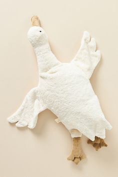 a white stuffed bird on a beige background