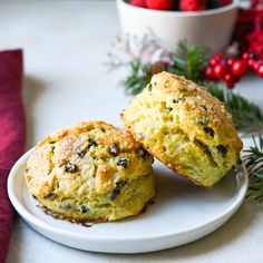 two muffins sitting on top of a white plate