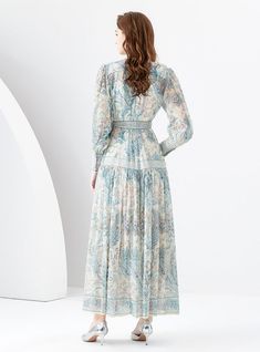 Poised with an air of sophistication, this enchanting maxi dress boasts a harmonious blend of vintage-inspired paisley prints and a modern silhouette. The high-neck design is elegantly countered by a cinched waist, which unfolds into a gently flared skirt, creating a figure-flattering profile that accentuates natural grace. The soft, pastel palette of this garment whispers of early spring gardens, while its long sleeves culminate in buttoned cuffs, adding a touch of classic refinement. This dres Elegant Fitted Maxi Dress With Paisley Print, Fitted Long Sleeve Paisley Print Maxi Dress, Elegant Flowy Paisley Print Dress, Spring Paisley Print Maxi Dress, Flowy Paisley Print Maxi Dress, Flowy Maxi Dress With Paisley Print, Spring Gardens, High Neck Designs, Pastel Palette