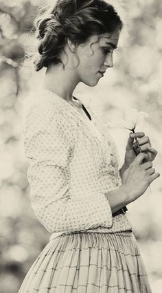 black and white photograph of a woman holding a flower