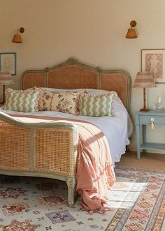 a bed with wicker headboard and foot board on top of carpeted floor