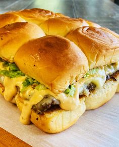 a cheeseburger is cut in half on a cutting board