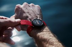 a man is holding the wrist of another person with their hand on his watch face