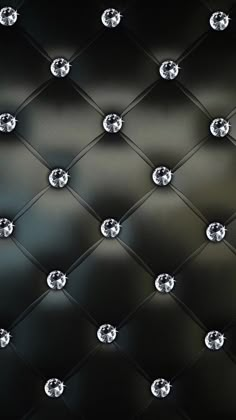 an up close photo of some diamonds on a black background with white and gray lights