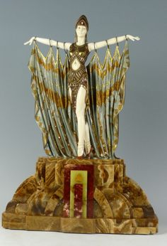 a statue of a woman standing on top of a table