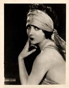 an old black and white photo of a woman wearing a turban